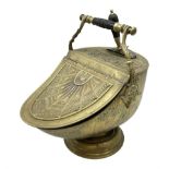 Victorian brass helmet shaped coal scuttle with embossed decoration and turned wooden handle and sho