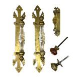 Pair of brass door handles with stylised fleur-de-lis motifs and cut glass handles