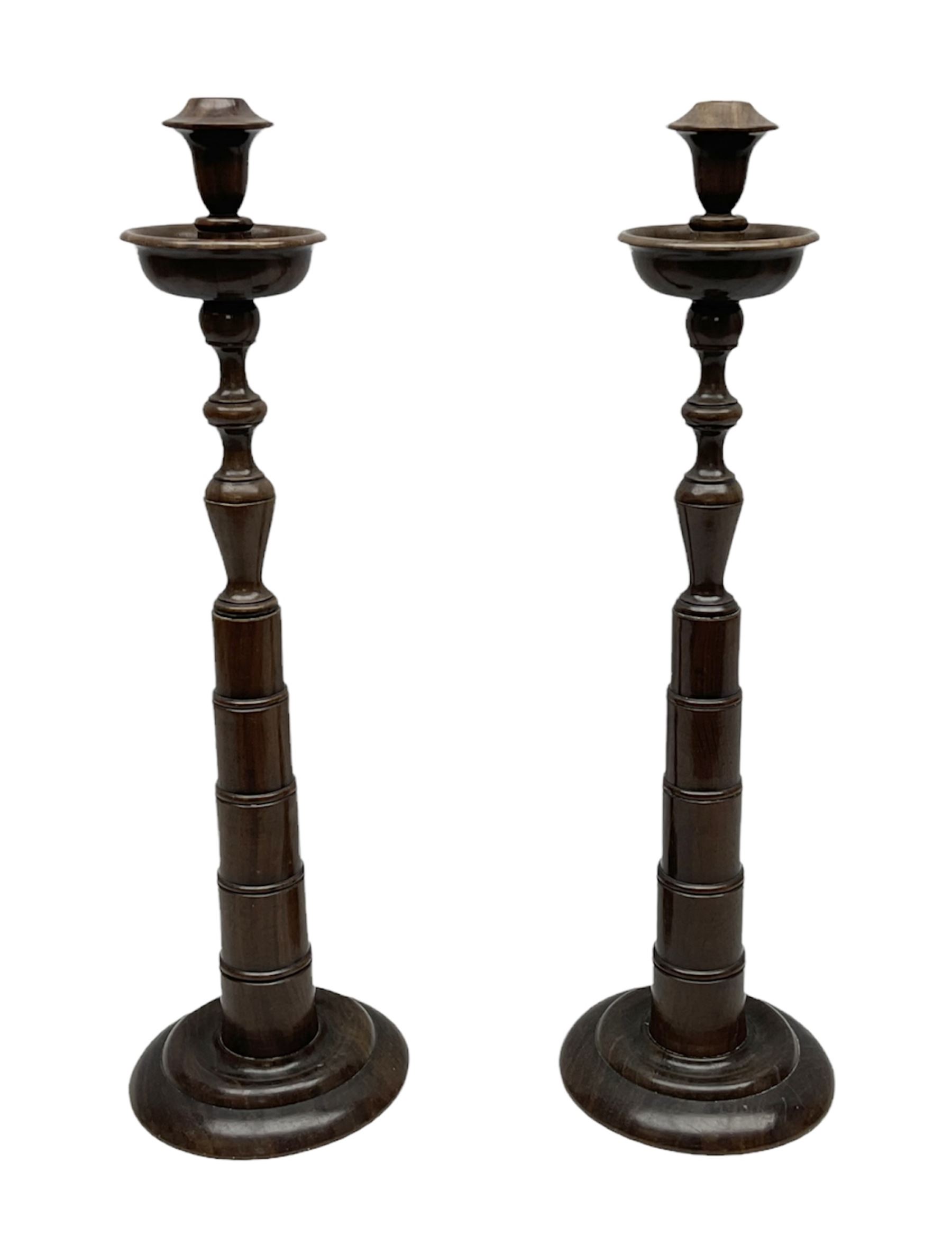 Pair of turned wooden candlesticks