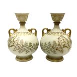 Pair of Royal Worcester ivory twin handled vases of baluster form