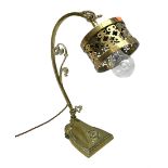 Brass adjustable wall light with a pierced shade and scroll decoration