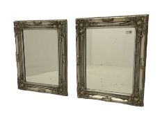 Pair of small wall mirrors in classical silver swept frame