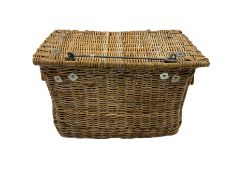 Large wicker basket with rope handles and metal fixtures