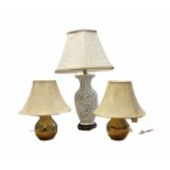 Blanc de Chine ceramic table lamp having a pierced body with lattice work decoration upon a wooden