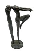 Bronze figure of a female nude with long flowing hair in stretched pose raised on circular base