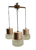 Mid century teak light fitting with three drop down clear glass pendants and copper mounts