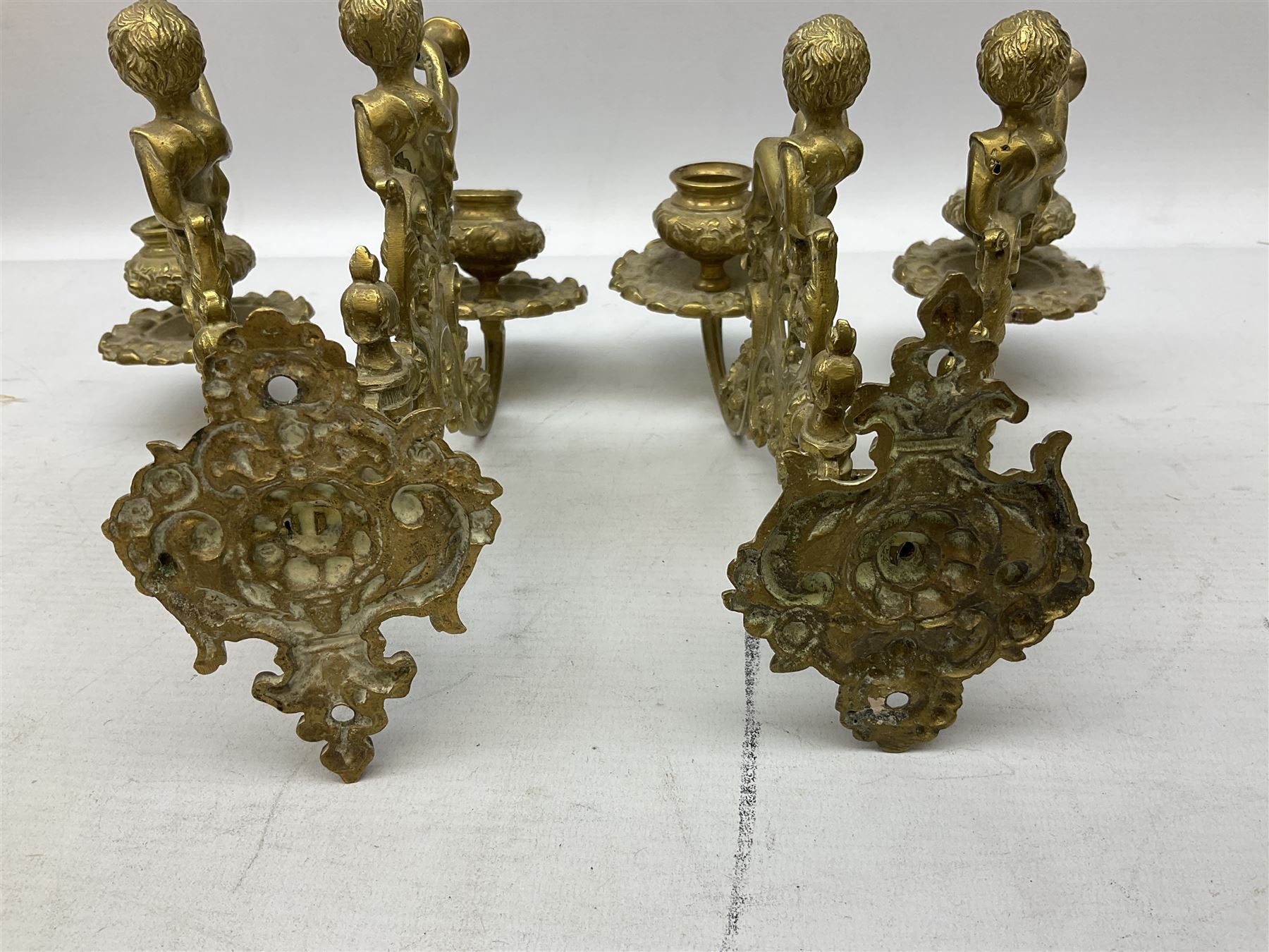 Two ornate brass wall sconces with twin branches modelled with cherubs playing trumpets - Image 4 of 5