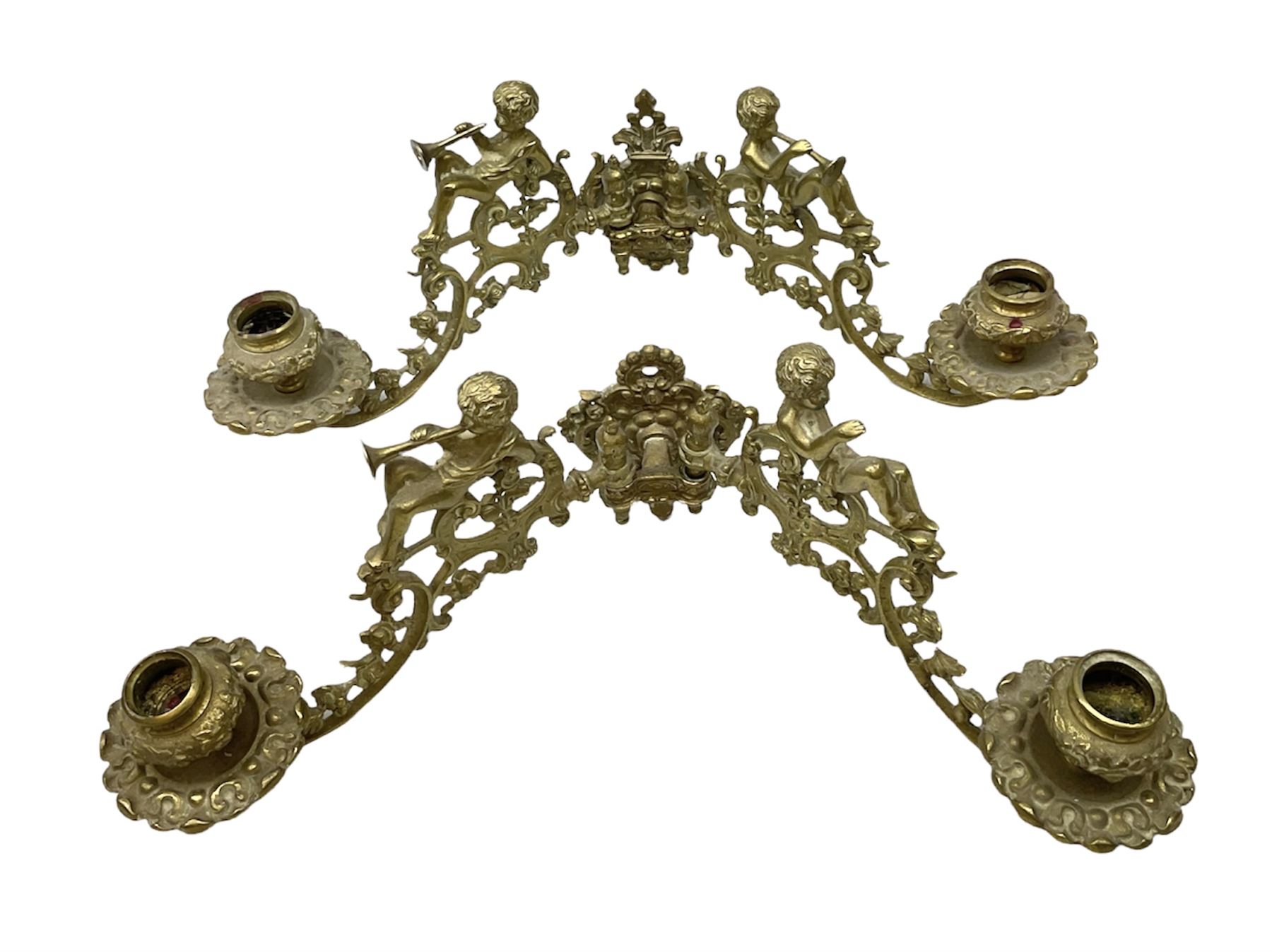 Two ornate brass wall sconces with twin branches modelled with cherubs playing trumpets