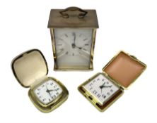 Two travelling alarm clocks with leather effect cases to include a Europa example