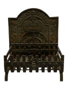 Ornate cast iron fire back with crown