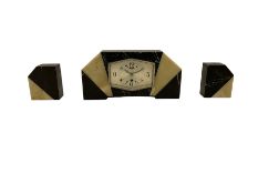 A 1930s French/Belgium Art Deco mantle clock in a black and cream "Sun Ray" marble case with two