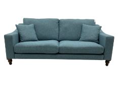 Large two seat sofa upholstered in denim blue fabric