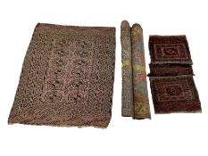 Three early Persian rugs and a saddle rug (4)