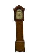 A provincial oak longcase clock retailed by “Geo Hunt, Amesbury” c1820, with a crested break arch