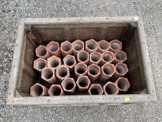 Twenty-seven terracotta land tiles formed as a pyramid shaped wine rack