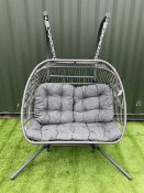 Metal and wicker two seat garden swing