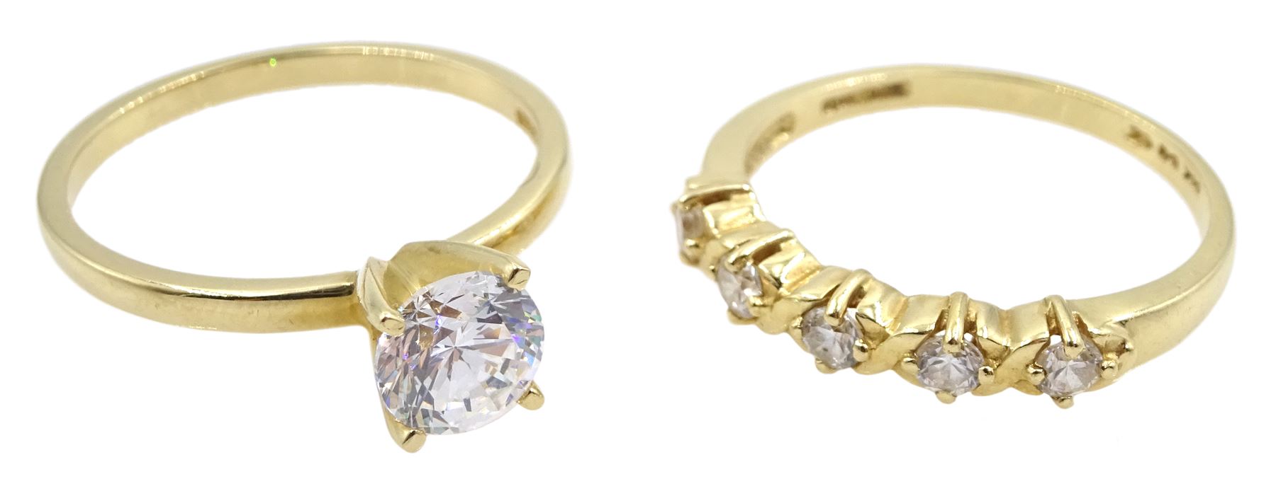 Gold single stone cubic zirconia ring and a gold five stone cubic zirconia ring
