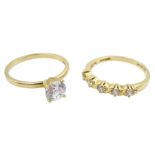 Gold single stone cubic zirconia ring and a gold five stone cubic zirconia ring