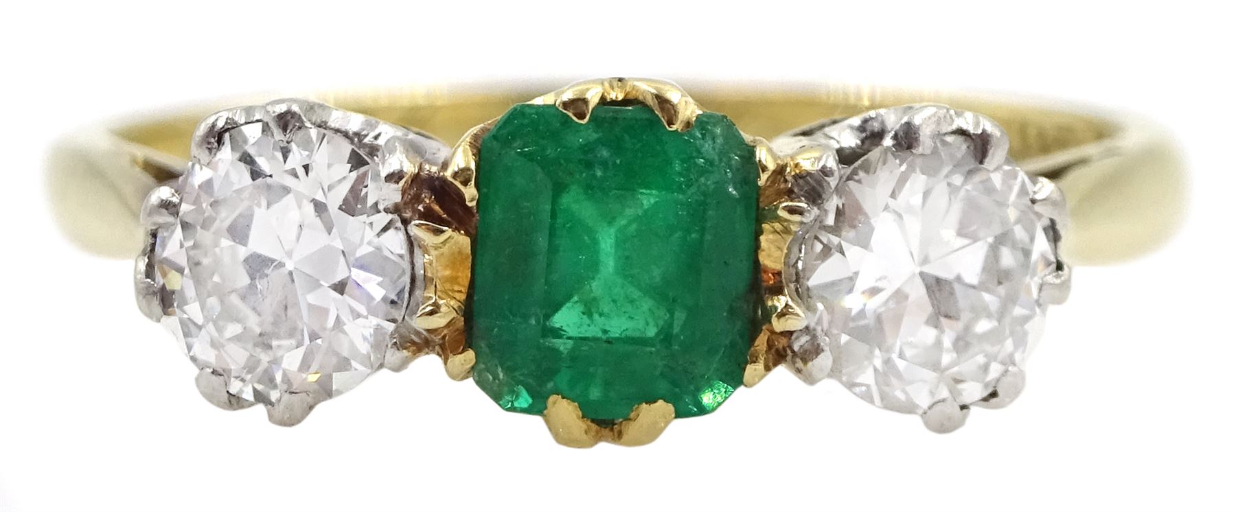 Early 20th century gold three stone old cut diamond and emerald ring