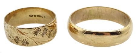 Gold wedding band with engraved decoration and one other