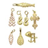 Eight gold charms including engraved cross set with single diamond