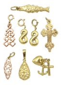 Eight gold charms including engraved cross set with single diamond