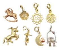 Three 14ct gold charms including hula girl