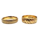 Two gold wedding bands with engraved decoration