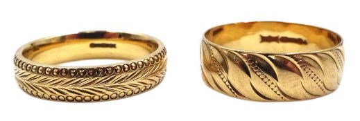 Two gold wedding bands with engraved decoration