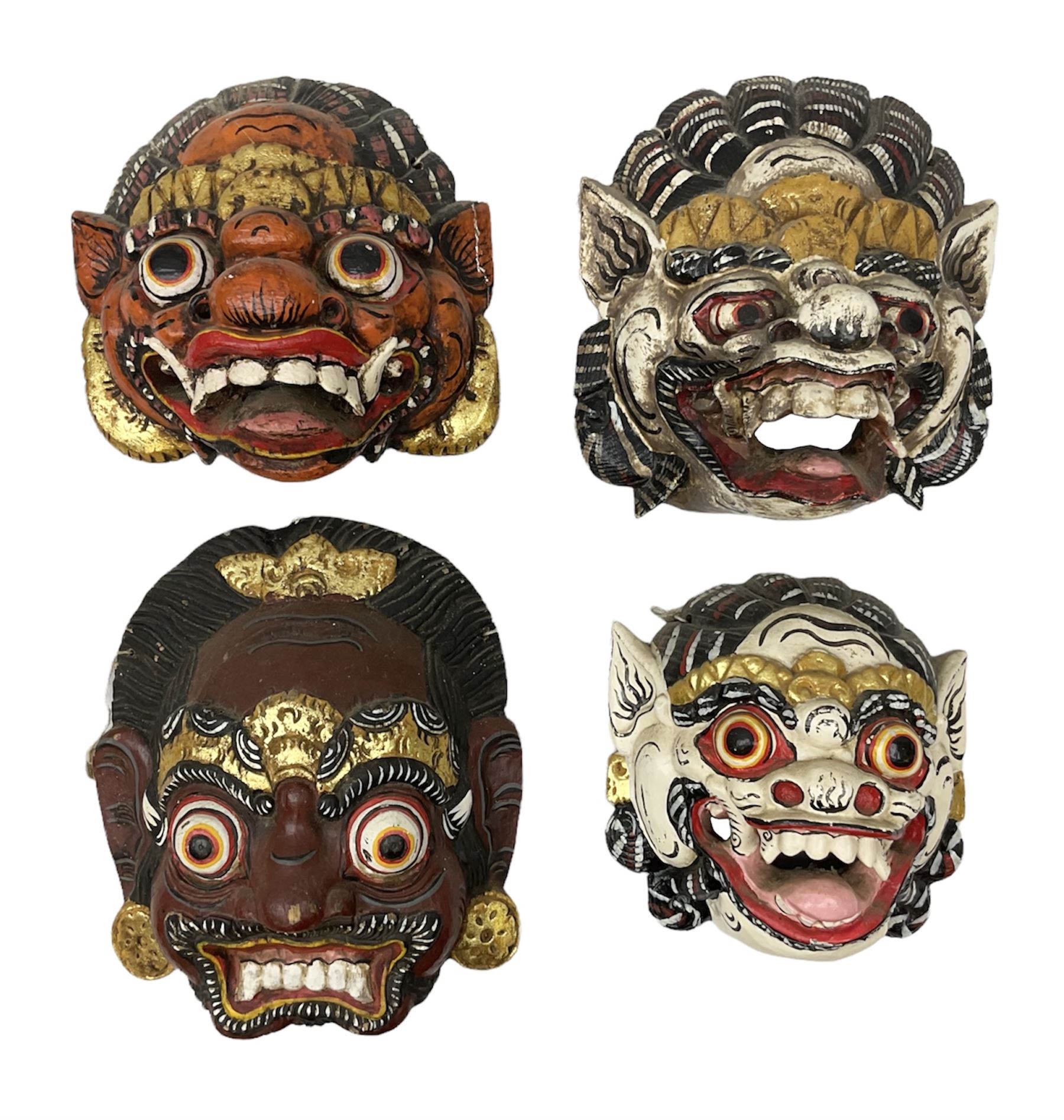 Four Balinese carved and painted wood dragon / demon masks
