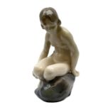 Royal Copenhagen 'Girl on Stone' figure modelled as a female nude seated upon a rock