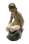 Royal Copenhagen 'Girl on Stone' figure modelled as a female nude seated upon a rock