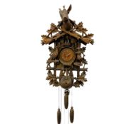 A large and imposing 20th century three train 30hr cuckoo clock with automata and musical features