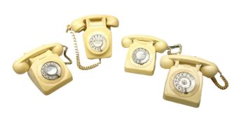 Four cream coloured telephones with rotary dials