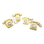 Four cream coloured telephones with rotary dials