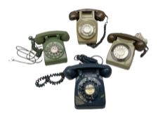 Four telephones with rotary dials