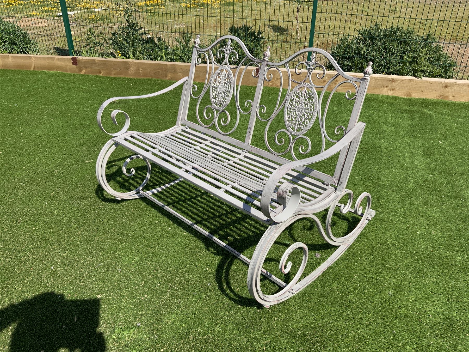 Wrought metal rocking garden bench seat