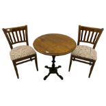 Pub table with circular top on cast ornate iron base; and two chairs