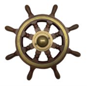Brass bound teak ship's wheel with eight turned spokes and brass hub