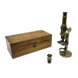 Victorian lacquered brass monocular microscope on circular base with ball and socket adjustment and