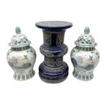 Oriental ceramics comprising blue jardeniere stand and pair of lidded urns decorated with blossoming