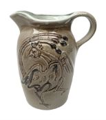 Studio pottery jug with applied decoration in the form of a bird on a brown ground H24cm