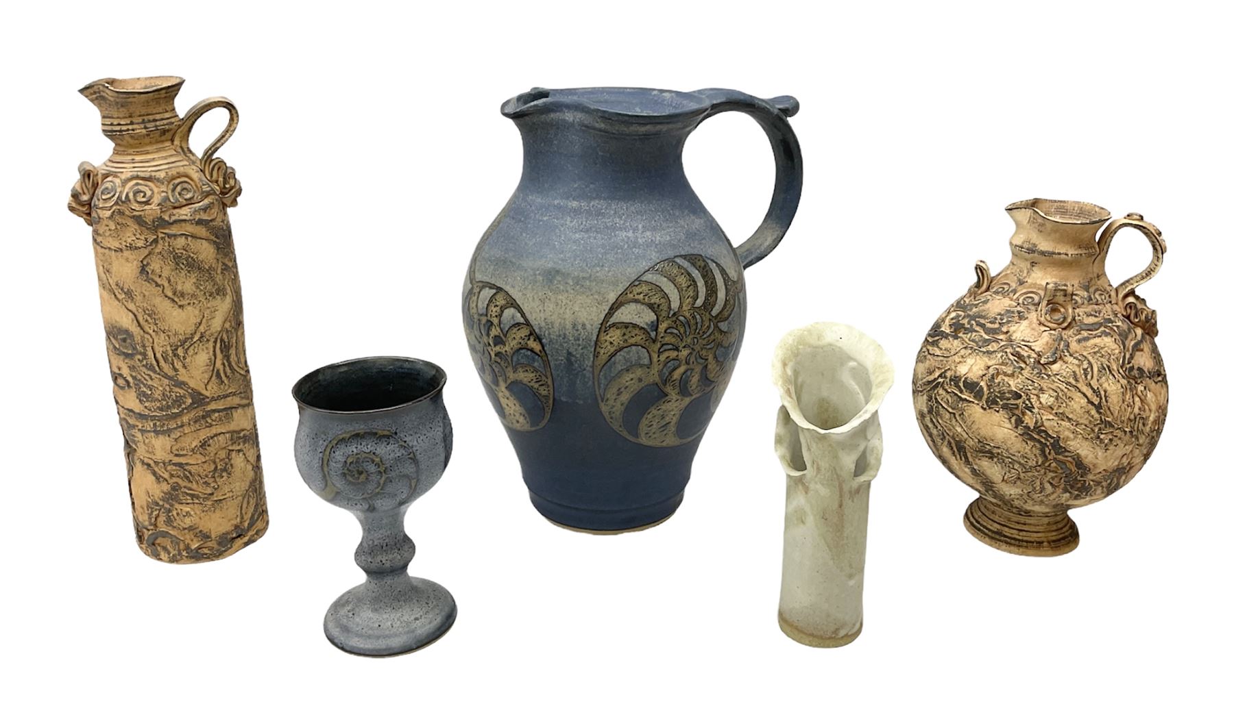 Group of studio pottery to include a large jug decorated with stylised ammonites upon a blue ground