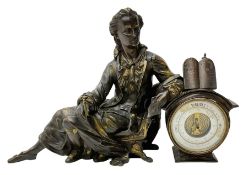 A late 19th century French aneroid barometer housed in a spelter case in the form of a reclining lad