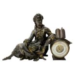 A late 19th century French aneroid barometer housed in a spelter case in the form of a reclining lad