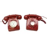 Two mid 19th century red telephones with rotary dials