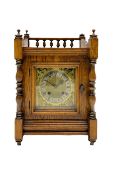 An early 20th century oak cased mantle clock in the arts and crafts style
