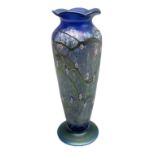 Okra vase decorated with stylised flowers on a mottled iridescent blue ground
