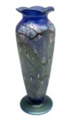 Okra vase decorated with stylised flowers on a mottled iridescent blue ground