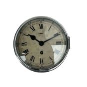 A bulkhead styled ships clock in a black metal case with an 8" chrome bezel and flat bevelled glass